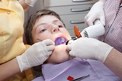 A young patient receiving a dental treatment.