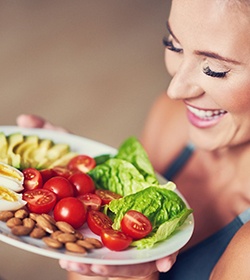 Woman holding plate of healthy foods