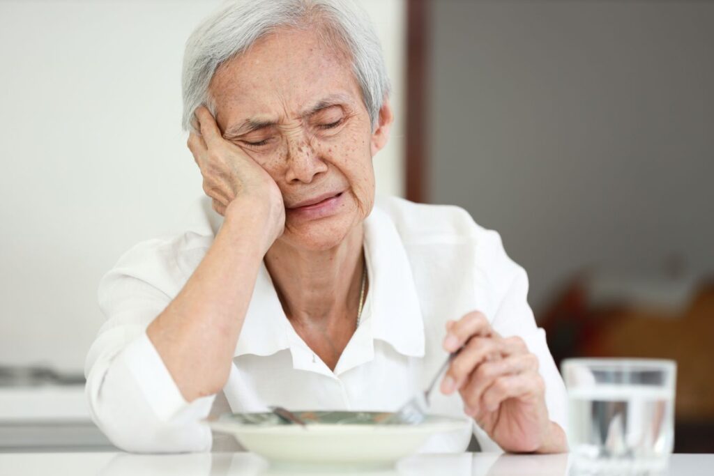 A woman repulsed by the flavor of her food